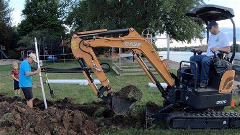 how to dig a ditch with a mini excavator|digging a drain without much slope.